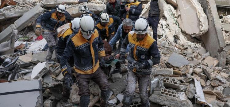 Syria Civil Defense volunteers removed a casualty from collapsed buildings in the village of Azmarin in rebel-held northwestern Idlib province. PHOTO: OMAR HAJ KADOUR/AGENCE FRANCE-PRESSE/GETTY IMAGES