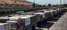 OCHA/David Swanson Trucks carrying food assistance cross the Turkish border into Syria. (file photo)