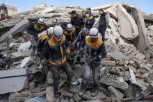Syria Civil Defense volunteers removed a casualty from collapsed buildings in the village of Azmarin in rebel-held northwestern Idlib province. PHOTO: OMAR HAJ KADOUR/AGENCE FRANCE-PRESSE/GETTY IMAGES